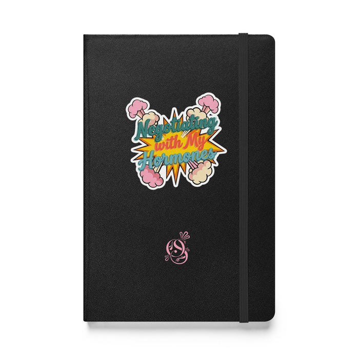 A5 hardcover notebook in charcoal matte black with "Negotiating with My Hormones" on the cover.