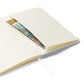 Close-up of the notebook's expandable inner pocket, open to show storage space for loose notes or cards.