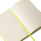 Open notebook showing cream lined pages and ribbon page marker.