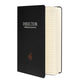 Charcoal matte hardcover notebook shown at an angle with its elastic closure band.