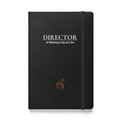 A5 hardcover notebook in charcoal matte black with "Director of Making It Up as I Go" on the cover.
