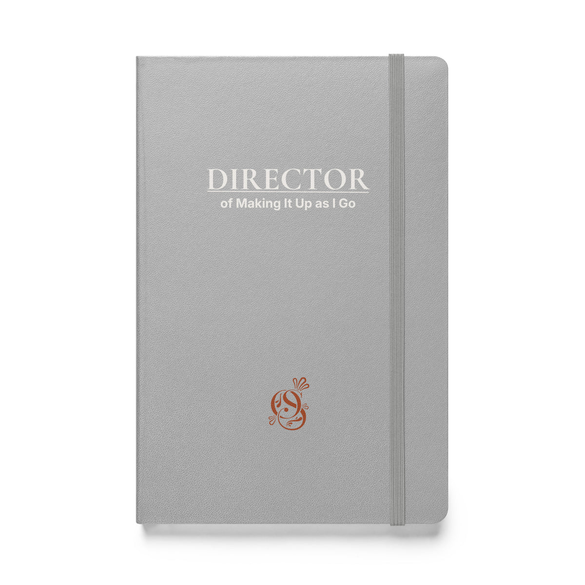 A5 hardcover notebook in matte silver-gray with "Director of Making It Up as I Go" on the cover.