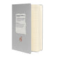 Matte silver-gray hardcover notebook shown at an angle with its elastic closure band.