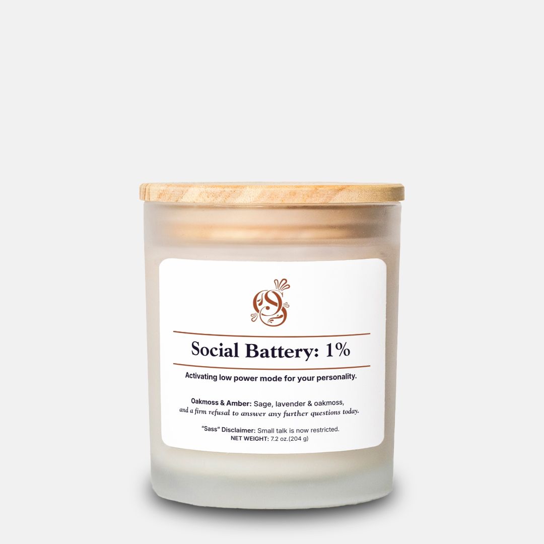 Social Battery: 1% candle in a frosted glass jar with a wood wick, Oakmoss & Amber scent.